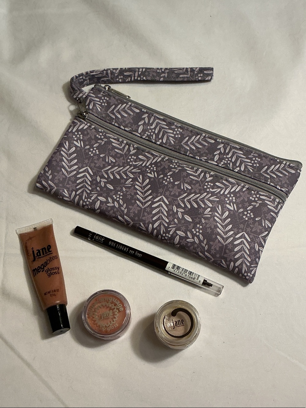 Cosmetics 5 pieces Brown Eyeliner & 3 shades of lip gloss w/ floral wristlet